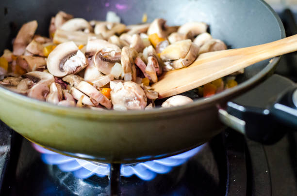 istock Champignons with onions are fried in pan, fire 1351889814