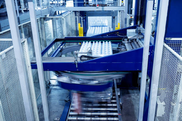 istock Modern strapping and transporting machine for packaging line at beverage plant. 1351890669