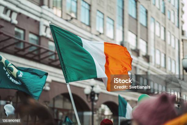 National Flag Of Ireland Closeup Above People Crowd Traditional Carnival Of St Patricks Day Stock Photo - Download Image Now