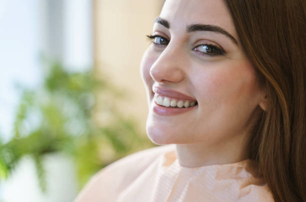 close up portrait of a smiling pretty woman is receiving dental checkup - healthy gums fotos imagens e fotografias de stock