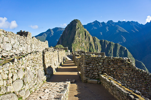 Ancient Inca city of Machu Picchu in the Andes. With stairs and terraces. walls. Clouds and mountains in the background. View into the valley. Peru. South America. Latin America.
