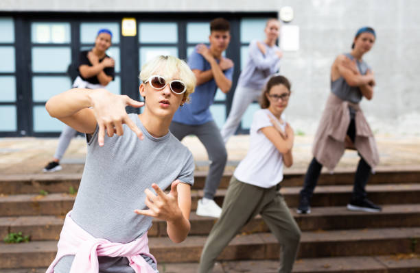 istock Modern teenager performing street dance with group 1351892271