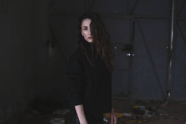 Young beautiful woman in abandoned building.