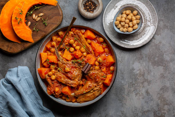 istock Pumpkin, lamb and chickpea stew with cinnamon sticks. Gray table surface, top view. 1351893459