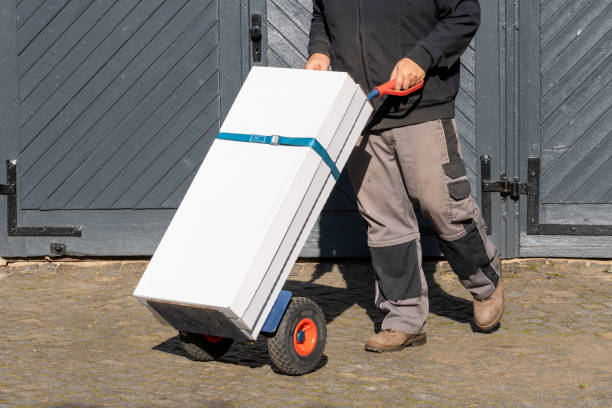 Courier with packages on a hand truck stock photo