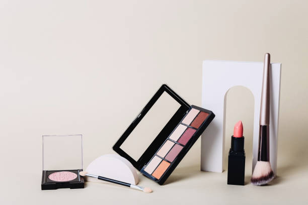 istock Makeup palettes with shadows and concealers. Make up products on beige background 1351893965