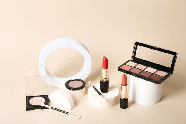 istock Makeup palettes with shadows and concealers. Make up products on beige background 1351893996