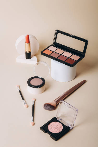 Makeup palettes with shadows and concealers. Make up products on beige background