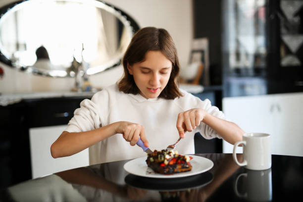 girl eating strawberry banana waffle