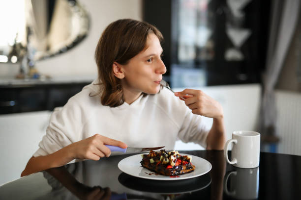 girl eating strawberry banana waffle