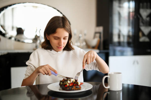 girl eating strawberry banana waffle