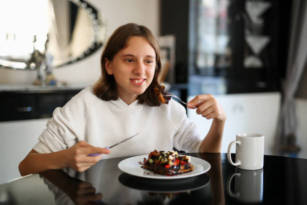 girl eating strawberry banana waffle