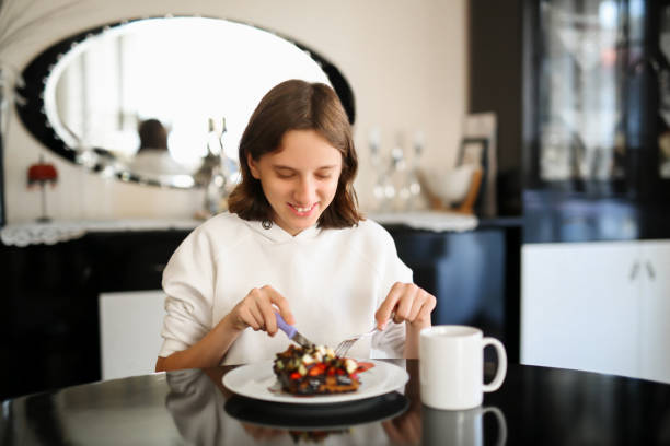 girl eating strawberry banana waffle