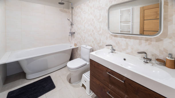istock Modern interior of bathroom. White sink, toilet, bath. Tile floor. 1351895583