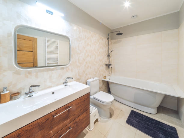 istock Modern interior of bathroom. White sink, toilet, bath. Tile floor. 1351895590