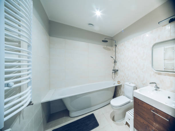 istock Modern interior of bathroom. White sink, toilet, bath. Tile floor. 1351895591