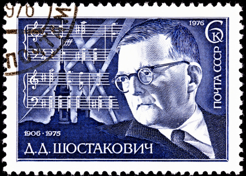 USSR- CIRCA 1976:  A stamp printed in the USSR shows a portrait of the Russian composer Dmitri Shostakovich and the score for his 7th Symphony, circa 1976.