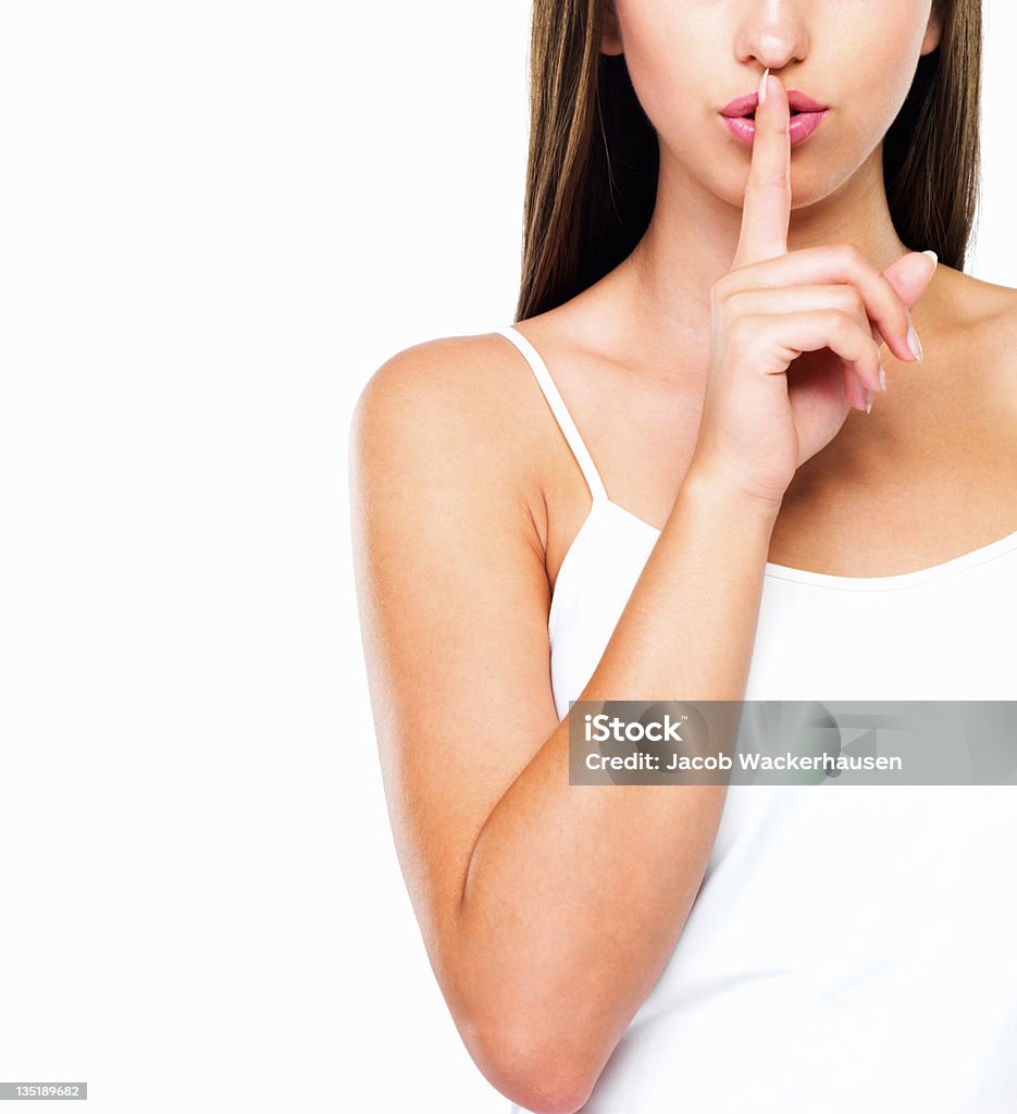 Hush Cropped image of beautiful woman with finger on her lips telling you to hush - Copyspace Women Stock Photo