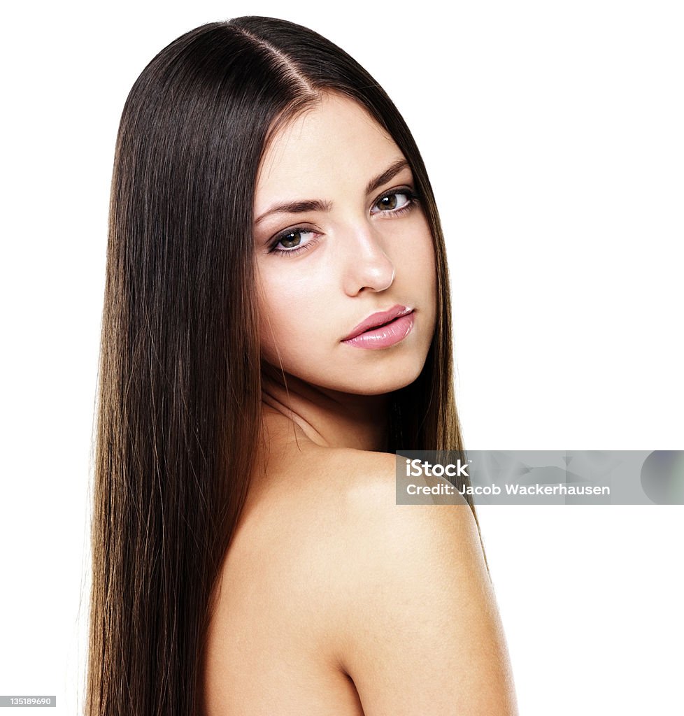 Hair to admire Gorgeous woman with long straight luxuriant hair posing on a white background 20-29 Years Stock Photo