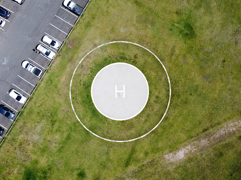 Helipad, helicopter lending place near parking lot, high point of view, background with copy space, horizontal composition