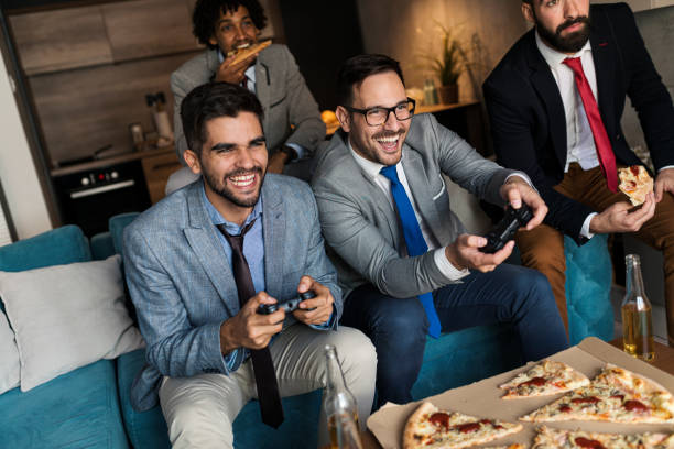 istock A group of young business man playing video games after work 1351901489