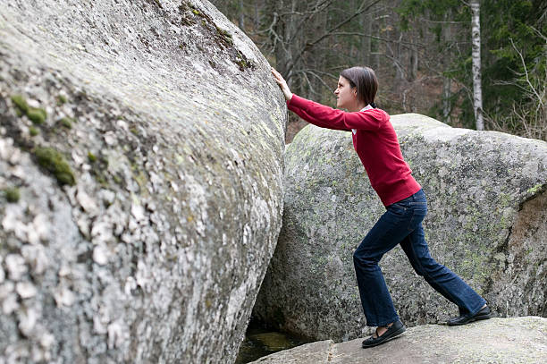 istock Girl pushing a stone 135190223