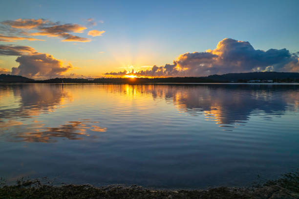 istock Aerial sunrise over the bay with clouds and reflections 1351904864