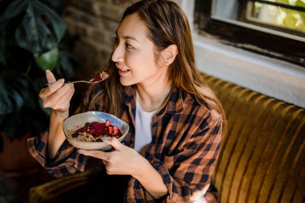 istock A modern Asian woman eats a fruit saladat a restaurant in Isnatbul 1351906969