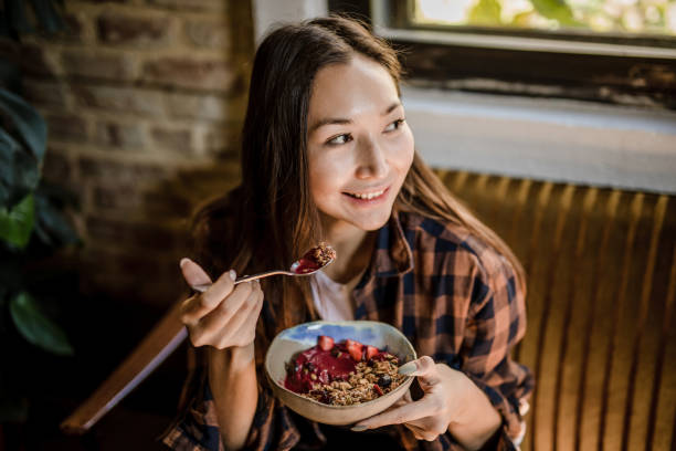 istock A modern Asian woman eats a fruit saladat a restaurant in Isnatbul 1351906972