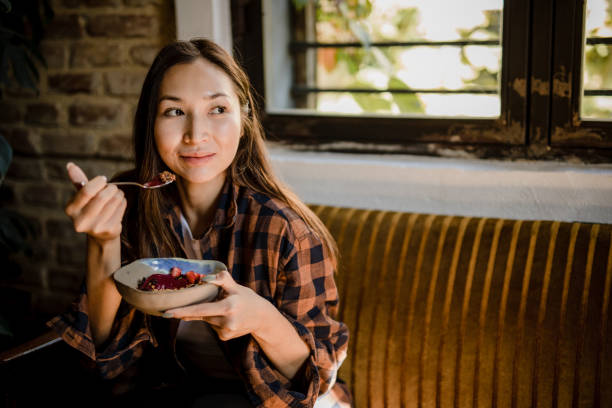 istock A modern Asian woman eats a fruit saladat a restaurant in Isnatbul 1351906975