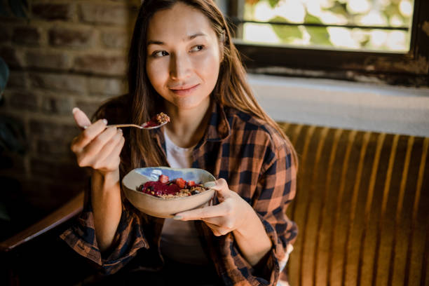 istock A modern Asian woman eats a fruit saladat a restaurant in Isnatbul 1351906976