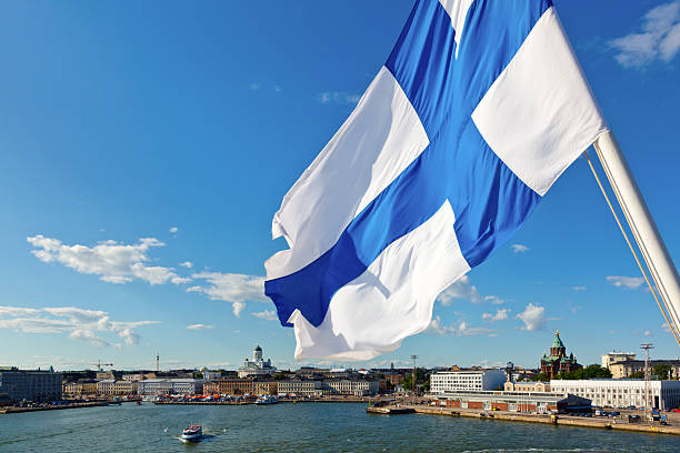 Waving Finnish Flag Flag of Finland against Helsinki panorama passenger craft photos stock pictures, royalty-free photos & images