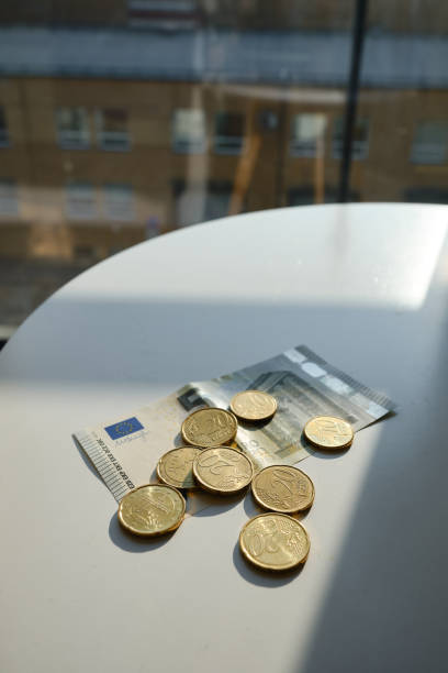 Close-up of euro coins and paper money on a white table. Savings financial literacy. Economy concept, investment, accounting. Saving money stock photo