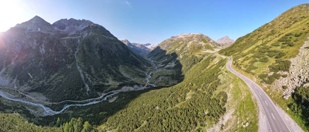 nascer do sol na estrada através de flüela pass, suíça - davos switzerland summer mountain - fotografias e filmes do acervo