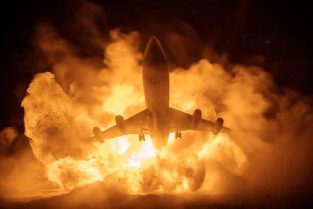 istock Air Crash. Burning falling plane. The plane crashed to the ground. Decorated with toy at dark fire background. Air accident concept. 1351910536