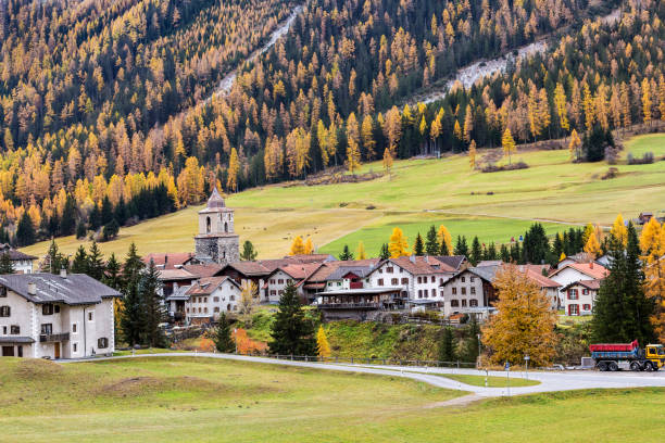 Magnificent autumn atmosphere of St.Moritz, famous and luxury ski resort town, located in the upper Engadin valley in the south-eastern corner of Switzerland. People walking along the lake on footpath.