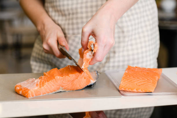 istock Removing fish bones. Butchering red fish meat. 1351912545