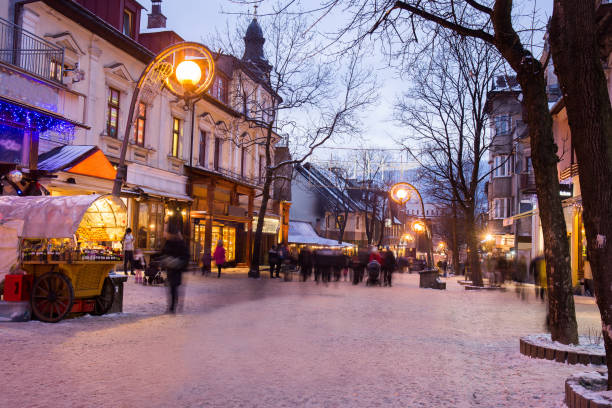 Zakopane town at blue hour , twilight. Blurred figures of people. Christmas  ( holiday) Illuminated  stores and cafe Zakopane town at blue hour , twilight. Blurred figures of people. Christmas  ( holiday) Illuminated  stores and cafe zakopane stock pictures, royalty-free photos & images