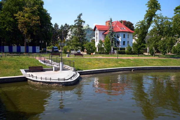 Street view in the Kaliningrad city (formerly Konigsberg). Old german house near cost lake, green trees and grass, blue sky