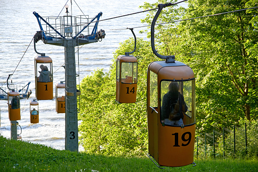 Cable car lift for tourists to beach of Baltic Sea in Svetlogorsk  resort town (until 1947 Rauschen). View to the mountainside with trees and sea, back light