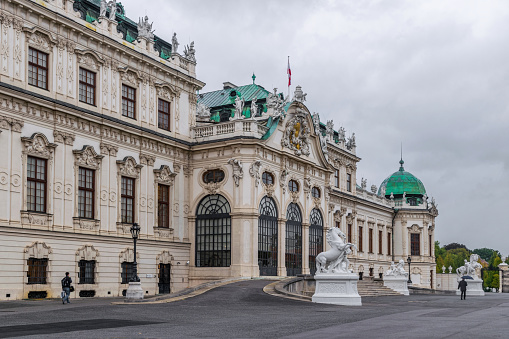 Vienna, Austria - October 06, 2021: Magnificent cascading fountains and sumptuous marble antique statues in the park of the Belvedere Palace in Vienna, the capital of Austria. Autumn rainy weather in Europe. Popular tourist and historical attraction, baroque architecture