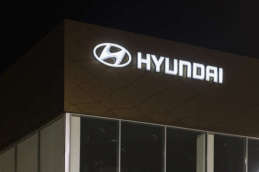 Hyundai logo on car dealership building at night - Hyundai is a South Korean multinational car manufacturer - Tula, Russia, 02 11 2021