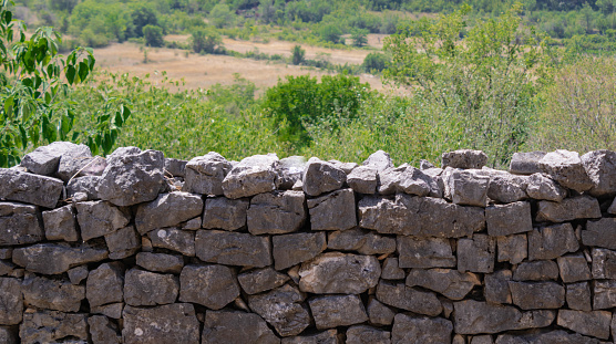 Characteristic stone drywall in Crotia, green nature background