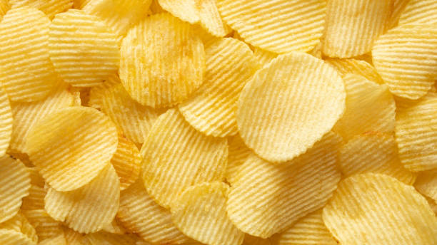 istock crispy golden potato chips snack texture background 1351935147
