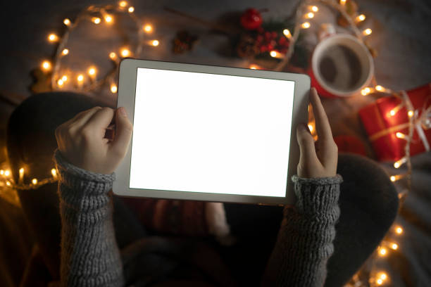 istock Scattered Christmas decorations and a blank digital tablet screen 1351935314
