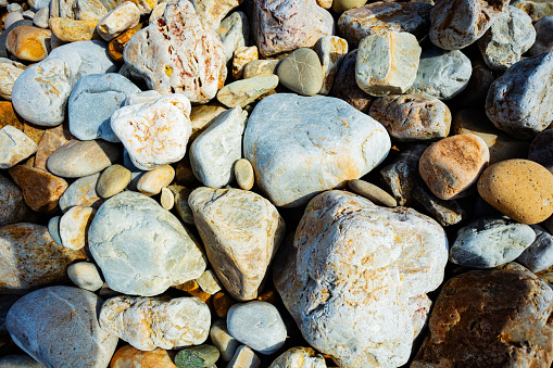 Close-up of sea stones pebbles and rocks background view from above
