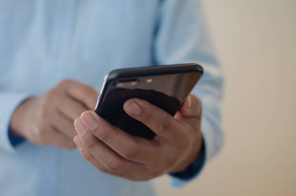 istock Close up of a man using mobile smart phone 1351936225
