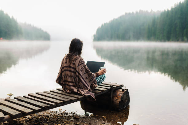 istock Woman Relaxing In Nature And Using Technology 1351936252