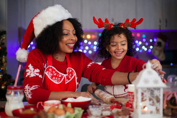 istock African-American mother and daughter having fun while making Christmas cookies. 1351937357