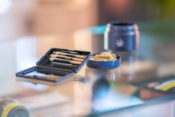 Legal Cannabis Product An assortment of cannabis product is laid out and displayed neatly on the counter of a legal retailer. Joints and cannabis bulbs can be seen laying in their packaging on the glass counter. Marijuana in Canada stock pictures, royalty-free photos & images